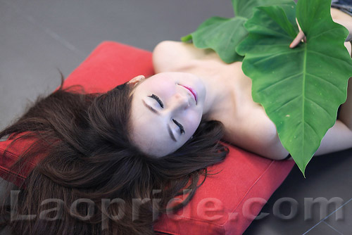 Lao girl covers her breasts with taro leaves