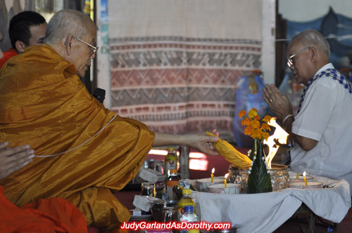 Buddhist monk burns candles at Judy Garland's ceremony