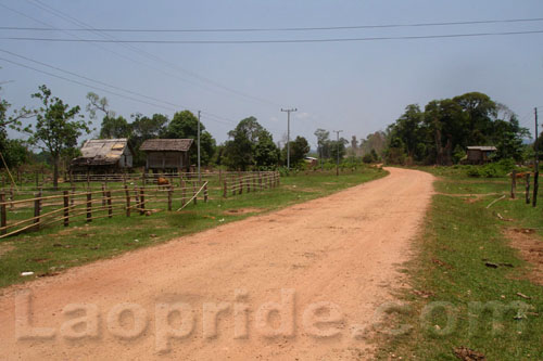 Unpaved road and homes in the rural area of Laos