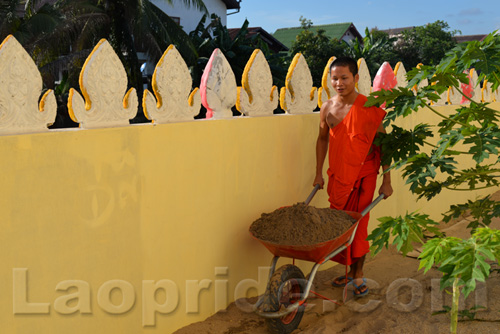 Buddhist monks are hard at work at the temple in Vientiane, Laos