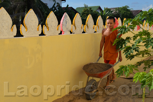 Buddhist monks are hard at work at the temple in Vientiane, Laos