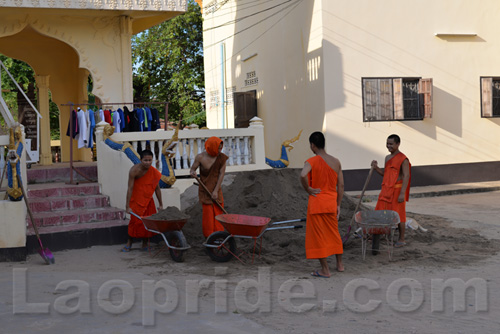 Buddhist monks are hard at work at the temple in Vientiane, Laos