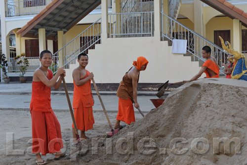 Buddhist monks are hard at work at the temple in Vientiane, Laos