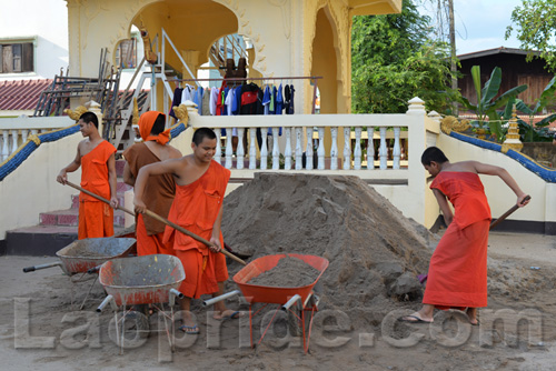 Buddhist monks are hard at work at the temple in Vientiane, Laos