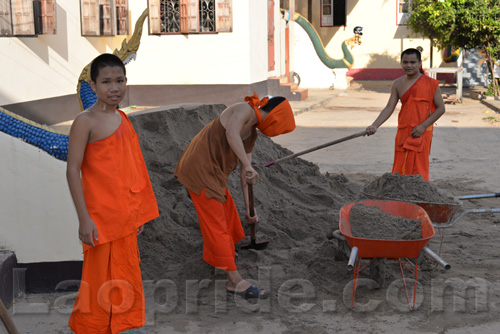 Buddhist monks are hard at work at the temple in Vientiane, Laos