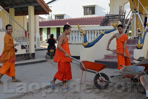 Buddhist monks are hard at work at the temple in Vientiane, Laos