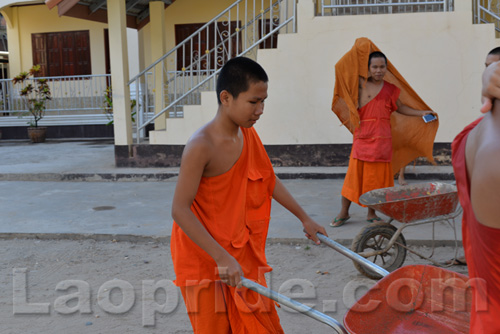 Buddhist monks are hard at work at the temple in Vientiane, Laos