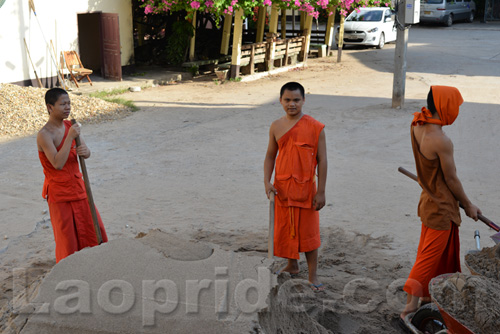 Buddhist monks are hard at work at the temple in Vientiane, Laos