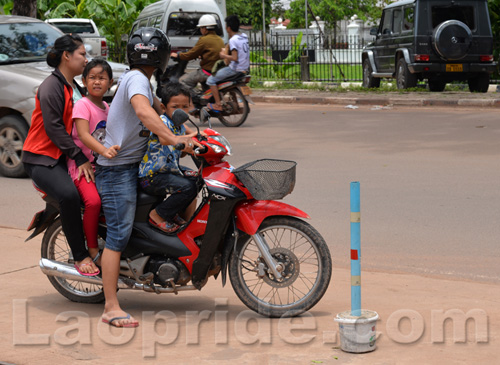 Four people riding a motorbike in Laos