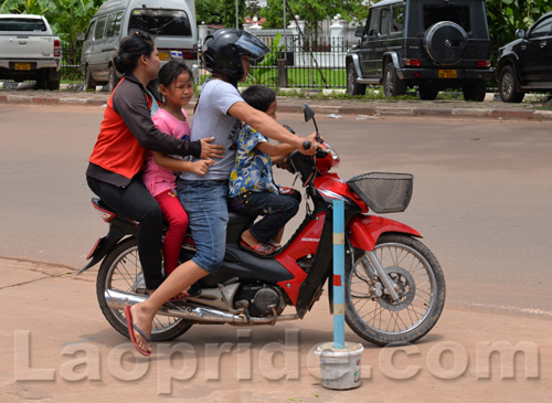 Four people riding a motorbike in Laos