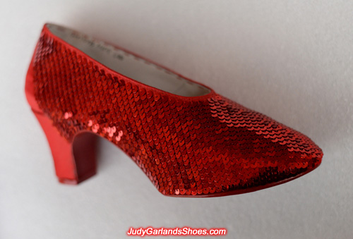 Hand sewing the sequins on the right shoe