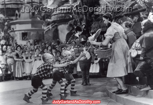 Judy Garland as Dorothy receives a lollipop from the Lollipop Guild