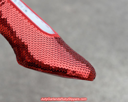 Sewing the sequins on the ruby slippers to a high standard