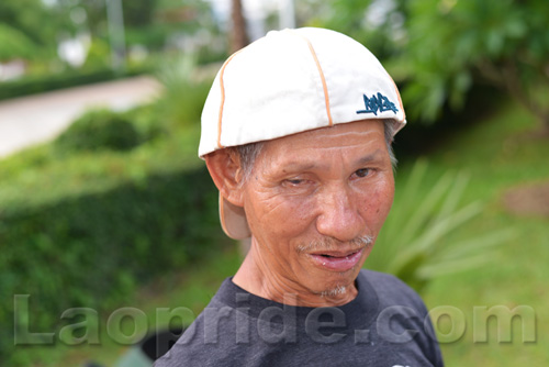 Vietnamese man collecting cans and bottles in Vientiane, Laos