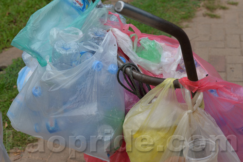 Vietnamese man collecting cans and bottles in Vientiane, Laos