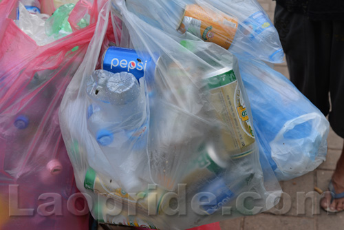 Vietnamese man collecting cans and bottles in Vientiane, Laos