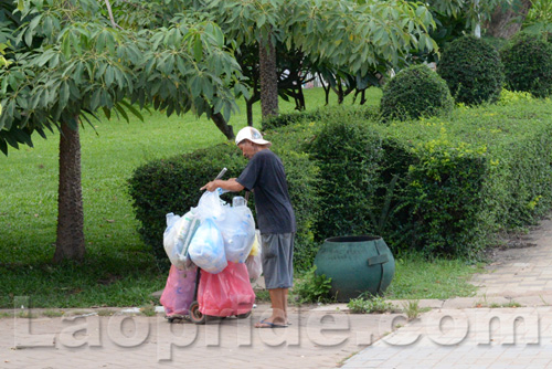 Vietnamese man collecting cans and bottles in Vientiane, Laos