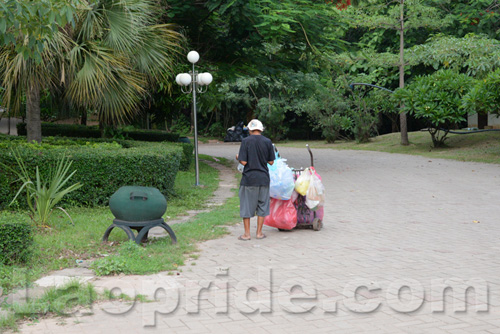 Vietnamese man collecting cans and bottles in Vientiane, Laos