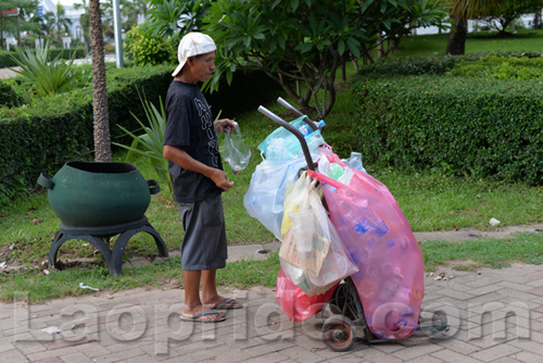 Vietnamese man collecting cans and bottles in Vientiane, Laos