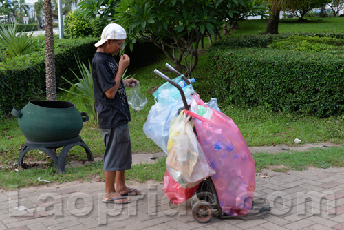 Vietnamese man collecting cans and bottles in Vientiane, Laos