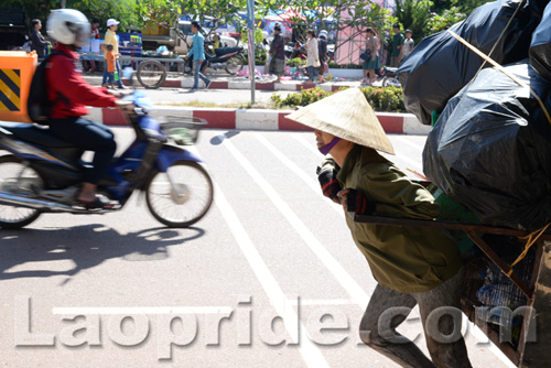 Vietnamese woman collecting trash to sell in Laos