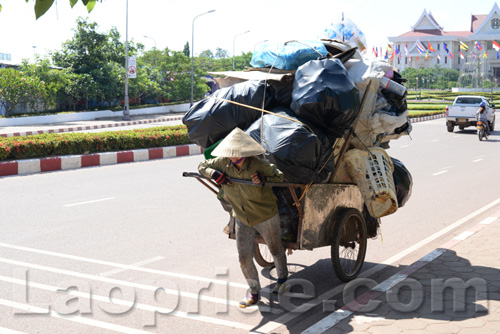 Vietnamese woman collecting trash to sell in Laos