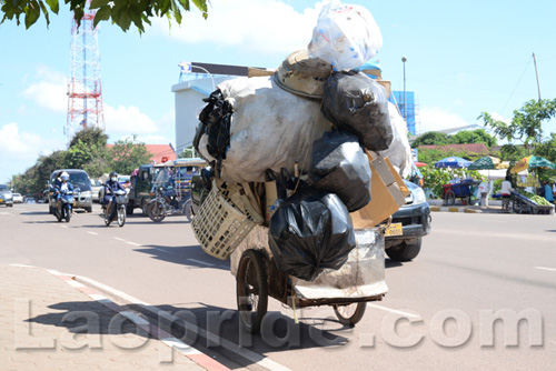 Vietnamese woman collecting trash to sell in Laos