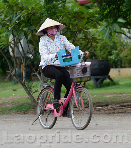 Vietnamese women working on bicycles in Vientiane, Laos