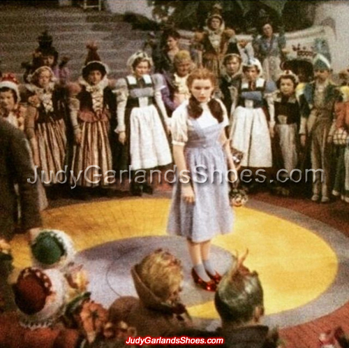 Judy Garland as Dorothy behind-the-scenes on the set of Munchkinland